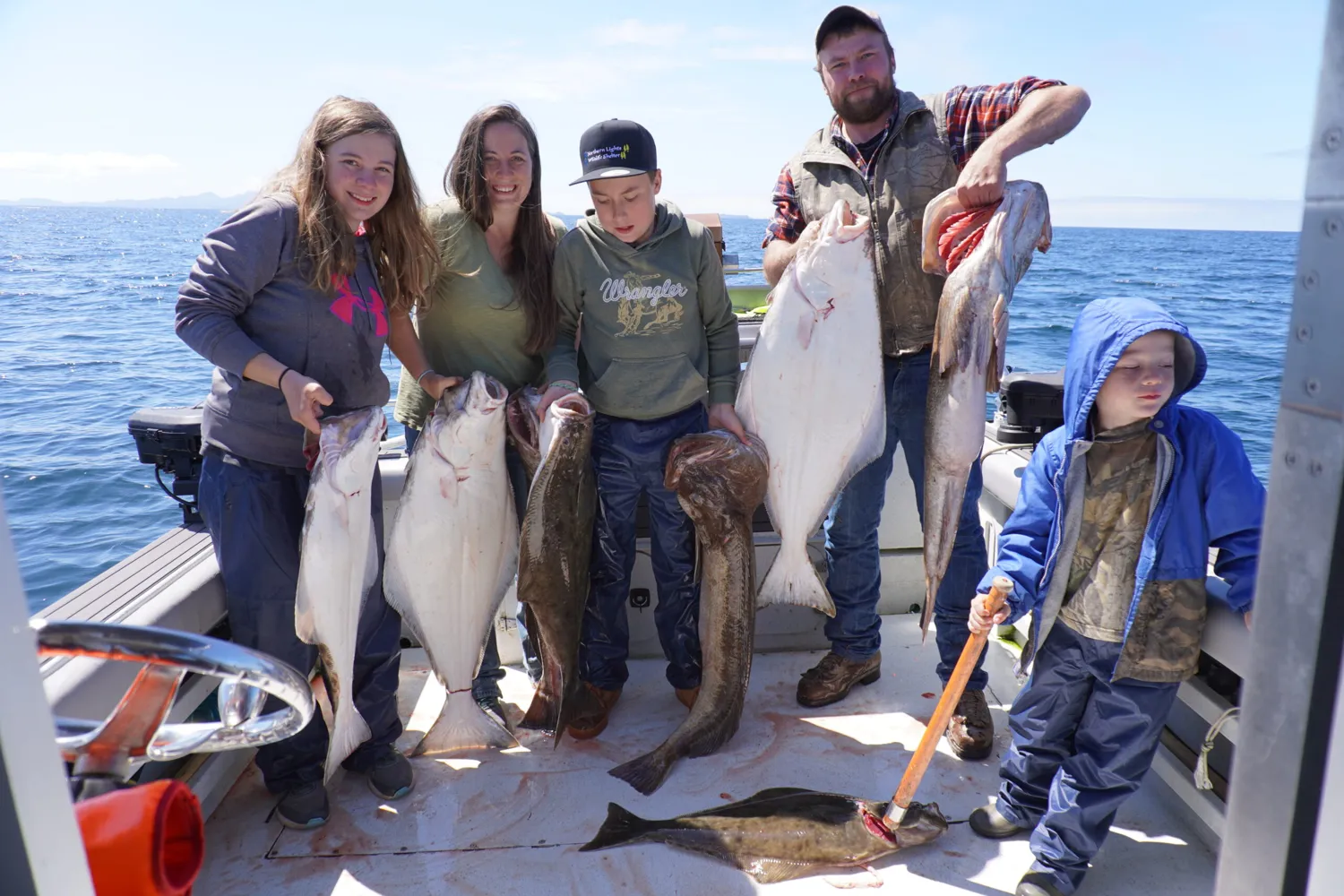 A group displaying their catch after a fishing trip