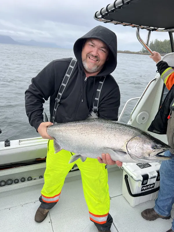 Guest with a salmon during a DC Charters fishing trip